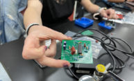 The Rochester iGEM team’s Bio-Spire device collects a tiny amount of sweat from a patient’s skin, then wicks the sweat past an integrated set of electrodes covered in biomarker detectors. (Photo courtesy of Rochester’s 2021 iGEM team)