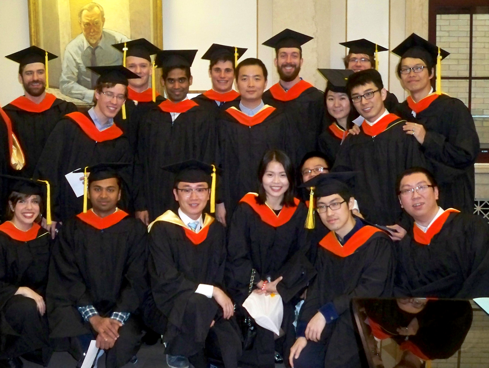 A group of graduates wearing their caps and gowns.