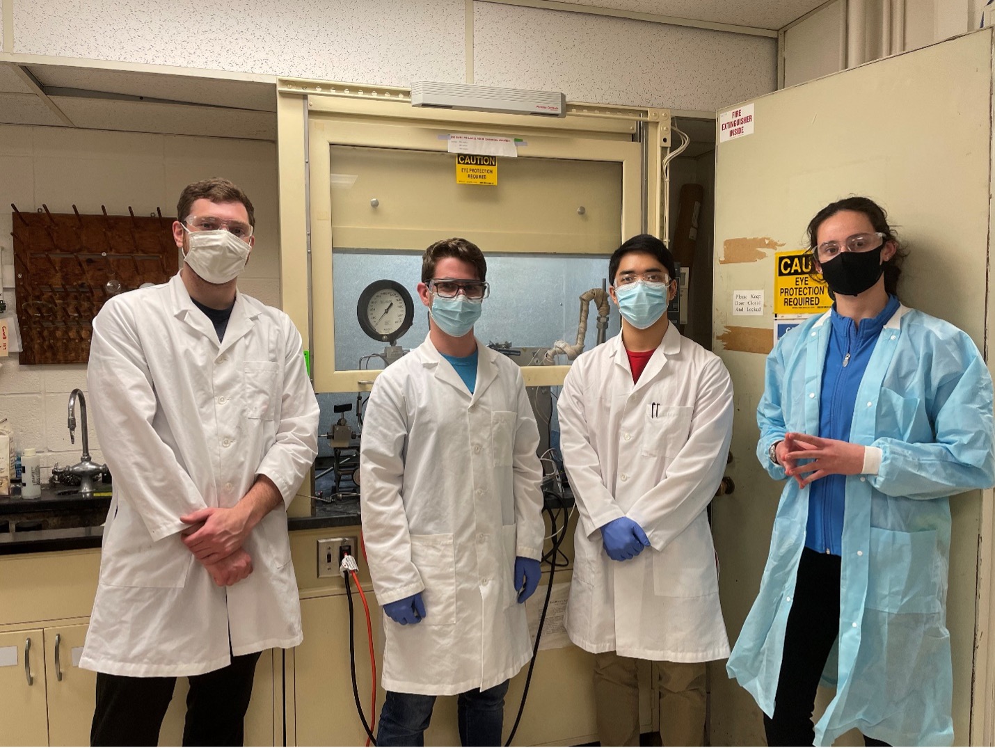 A group photo of students wearing lab coats.
