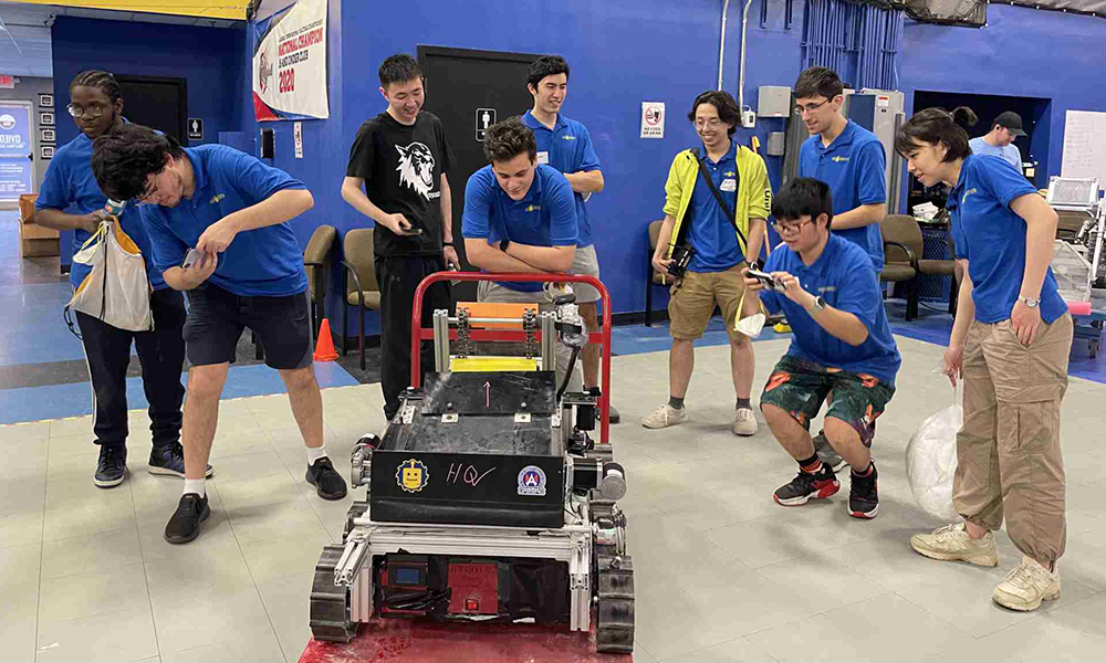 Undergraduate engineering students in matching t-shirts with their lunar rover robot for NASA's 2024 Lunabotics Challenge.