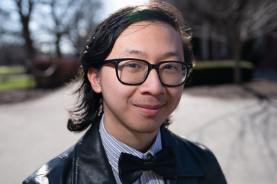 Man smililng at camera wearing glasses