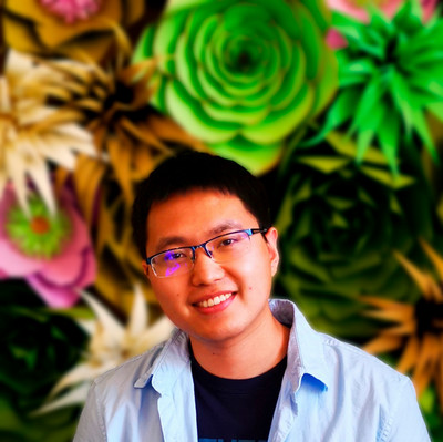 person smiling at camera wearing blue shirt