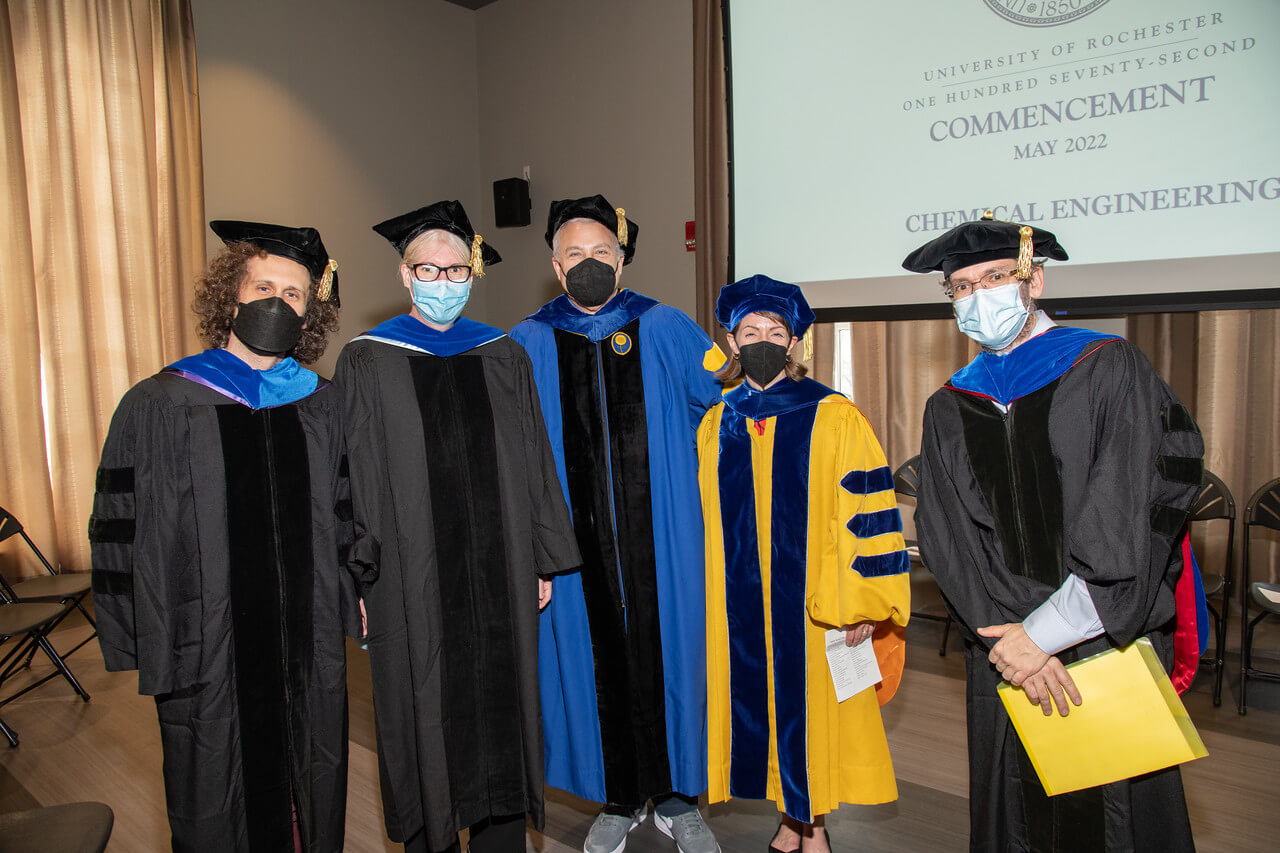 Graduates standing with their dean