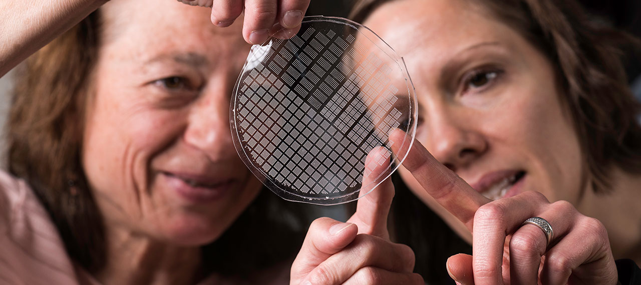 Two professors examining microbubbles.