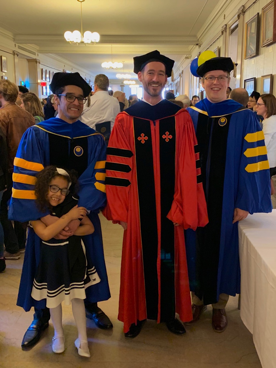 Rakan, Doug, and Thomas showing their academic regalia