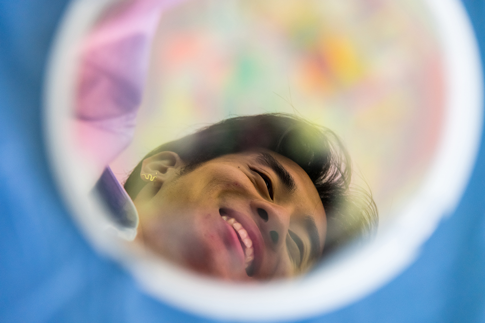 A face reflected in a colorful disc.