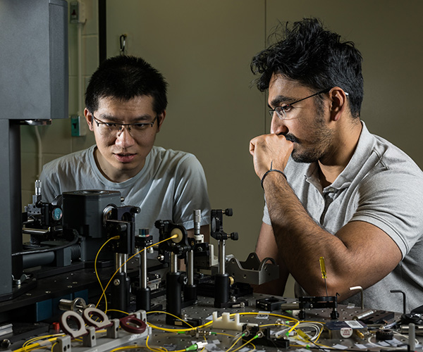 Two graduate students working on a project in a lab.