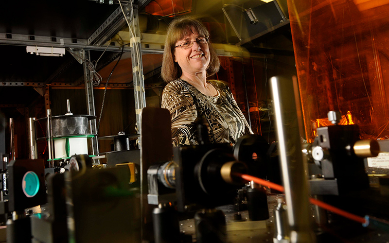 Strickland smiling at the camera in a lab setting.