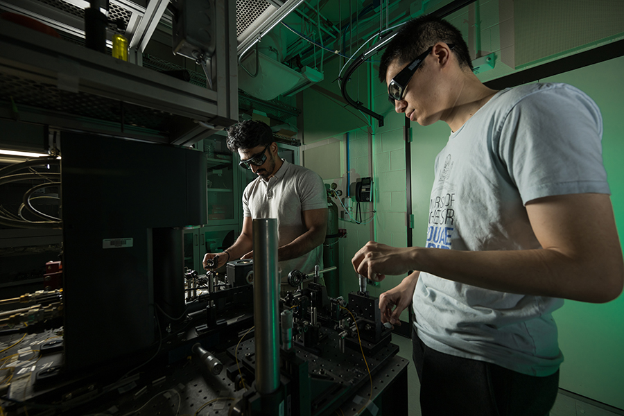 Two people working in a darkened lab.