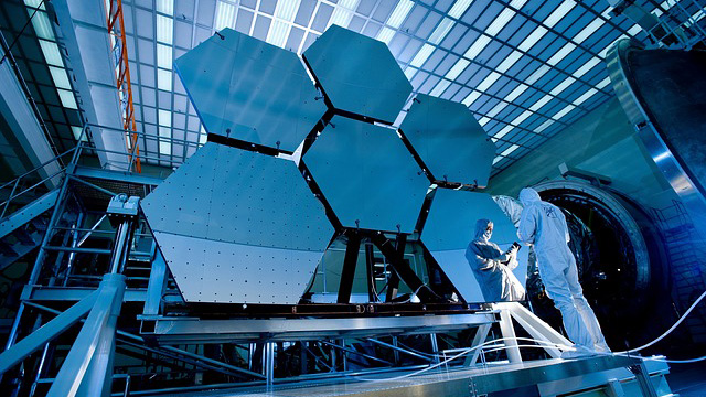 A technician checking the mirrors for the James Webb Space Telescope.