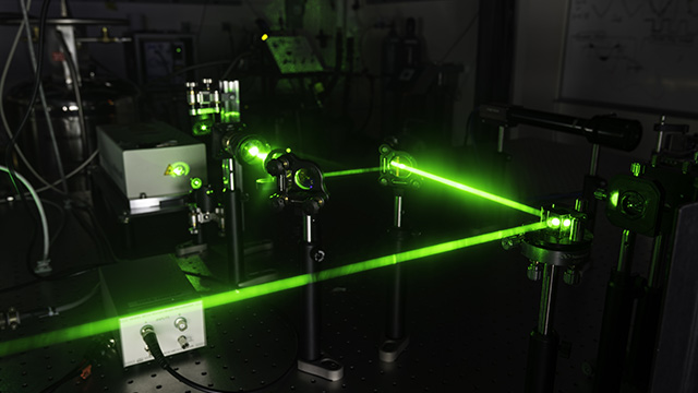 A laser beam bouncing between mirrors in a lab.