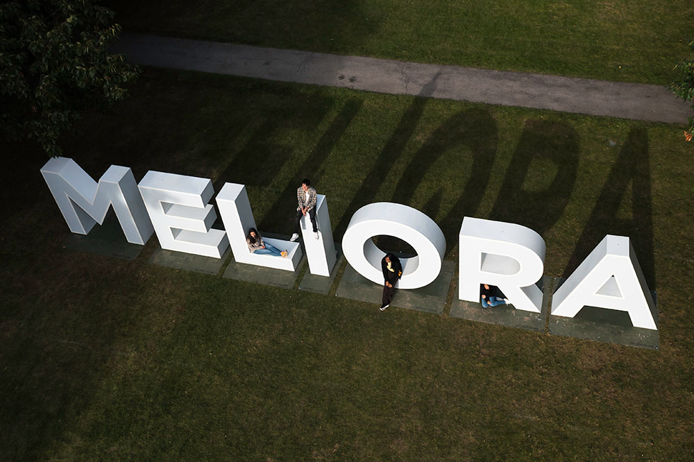 An aerial view of the ground where there are large white letters spelling meliora.