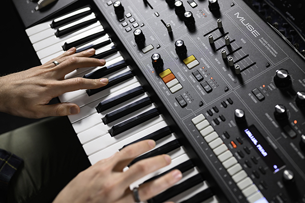 Two hands playing a keyboard.