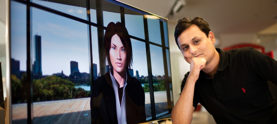 researcher in front of a screen with a computer simulation