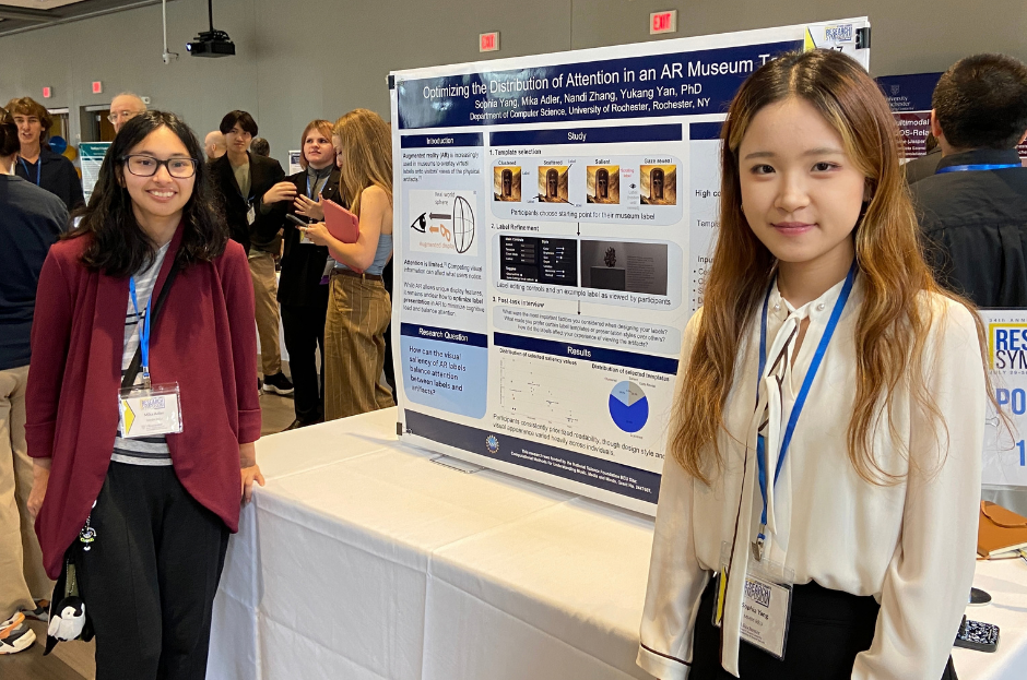 REU students presenting poster.