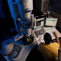 A student working on an electron microscope.