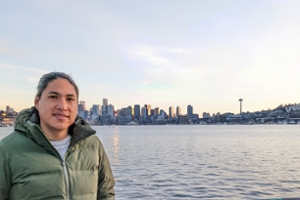 Juvenal looking at camera in front Seattle skyline