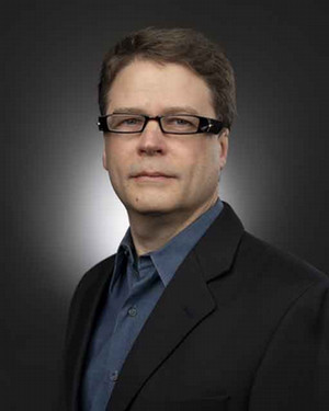 Man with glass looking at camera