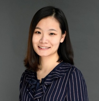 Woman smiling at camera wearing dark shirt 