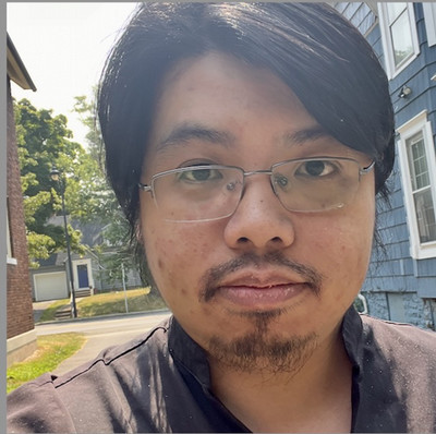 Many staring at camera wearing glasses with dark hair