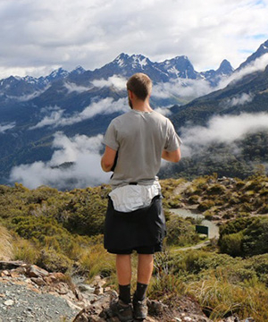 A student hiking a mountain.