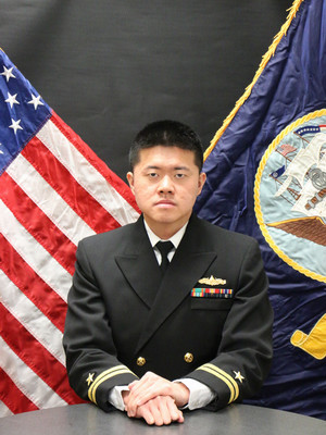 LT Jonghyuk Park, in his uniform, sitting at a table.  