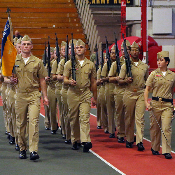 The battalion marching in formation in a gym.