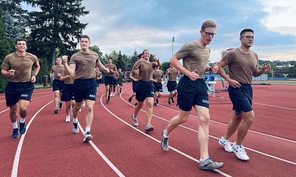 The battalion dressed in workout clothes and running laps on a track.