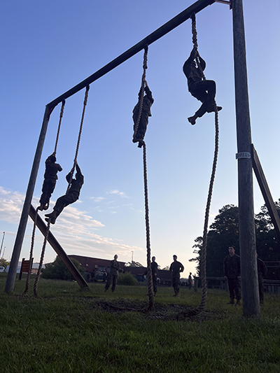 Midshipman climbing ropes.