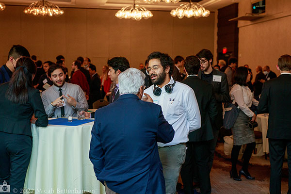 Industry members networking in the ballroom during the spring 2022 symposium.