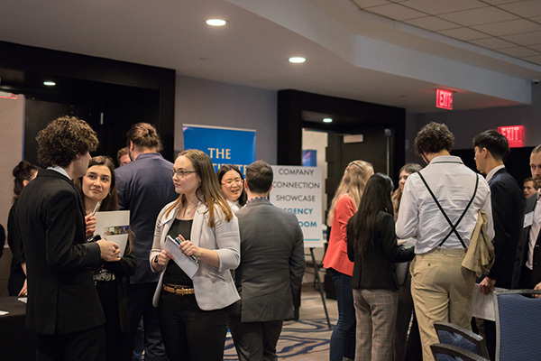 Students and industry networking at the 2022 spring symposium.