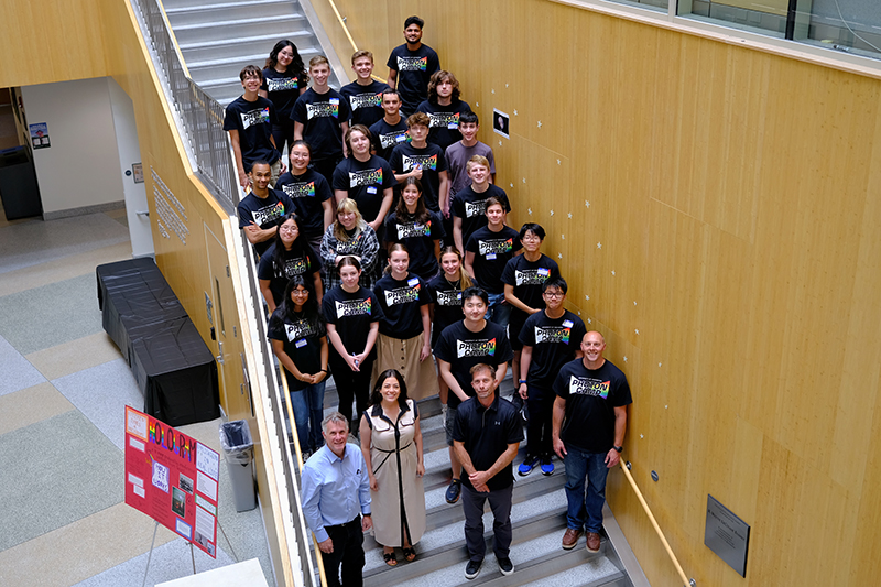 A group photo of all participants standing on a staircase.